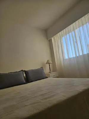 a bedroom with a large bed with a window at Urban 360 in Río Cuarto