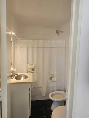 a white bathroom with a sink and a toilet at Urban 360 in Río Cuarto