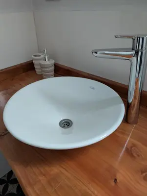 a white bathroom sink with a chrome faucet at Cabañas Terra in Villa Yacanto