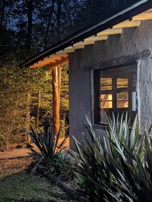 a small house with a window in a yard at Cabañas Terra in Villa Yacanto