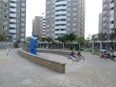 a group of people sitting around a fountain in a city at Departamento Temporario Villa Sol in Cordoba