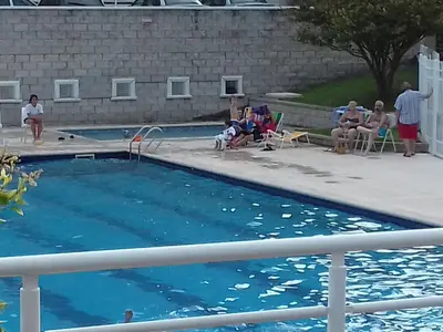 a group of people sitting around a swimming pool at Departamento Temporario Villa Sol in Cordoba