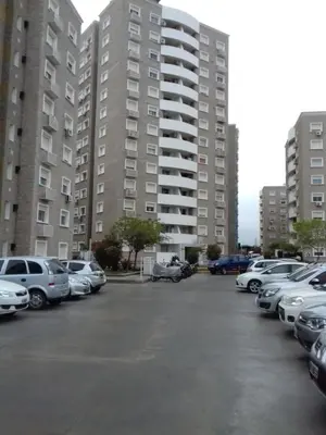 a parking lot with cars parked in front of tall buildings at Departamento Temporario Villa Sol in Cordoba