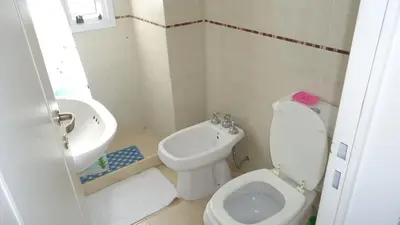 a small bathroom with a toilet and a sink at Departamento Temporario Villa Sol in Cordoba