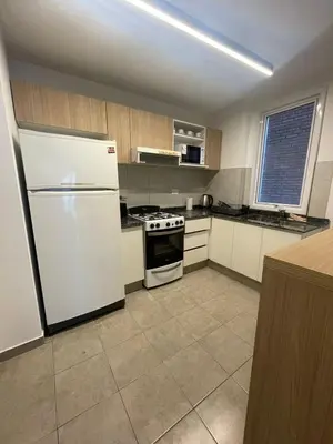 a kitchen with a white refrigerator and a stove at MILANO 2d2b - RF - Gral Paz - Hogares de Calidad in Cordoba