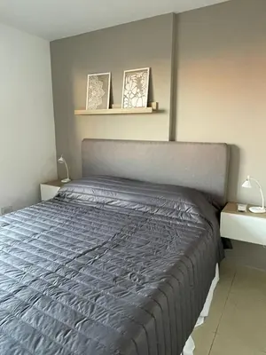 a bedroom with a bed with a gray comforter at MILANO 2d2b - RF - Gral Paz - Hogares de Calidad in Cordoba
