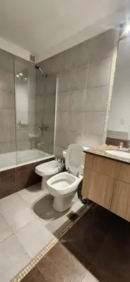 a bathroom with a toilet and a shower and a sink at MILANO 2d2b - RF - Gral Paz - Hogares de Calidad in Cordoba