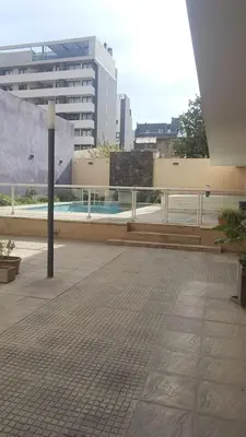 a balcony of a building with a pool and a pole at MILANO 2d2b - RF - Gral Paz - Hogares de Calidad in Cordoba