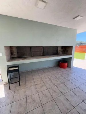 a bench in a room with a table and a chair at Departamento 1 dormitorio in Villa Carlos Paz