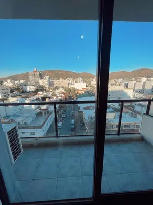a view of a city from a window at Departamento 1 dormitorio in Villa Carlos Paz