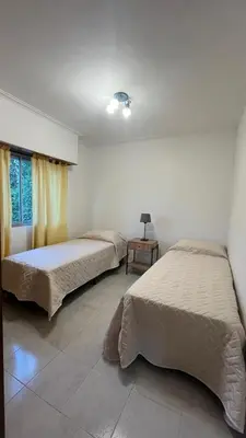 a bedroom with two beds and a window at Edificio ALEM CENTRO in Villa Carlos Paz