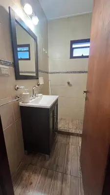 a bathroom with a sink and a mirror at Edificio ALEM CENTRO in Villa Carlos Paz