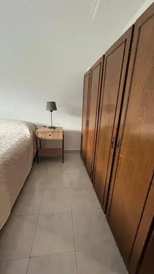 a bedroom with a row of lockers and a bed at Edificio ALEM CENTRO in Villa Carlos Paz