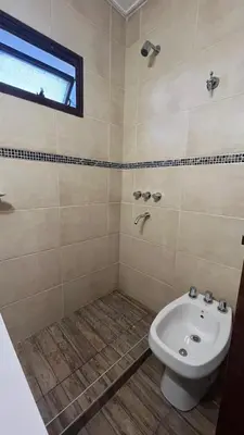 a bathroom with a toilet and a sink at Edificio ALEM CENTRO in Villa Carlos Paz