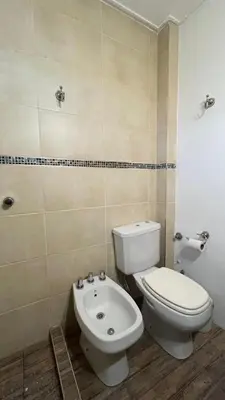 a bathroom with a toilet and a bidet at Edificio ALEM CENTRO in Villa Carlos Paz