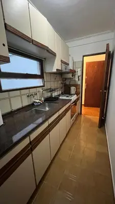 a kitchen with white cabinets and a sink and a window at Edificio ALEM CENTRO in Villa Carlos Paz