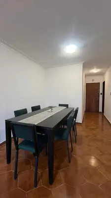 a black table and chairs in a room with a white wall at Edificio ALEM CENTRO in Villa Carlos Paz