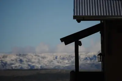 a view of a snow covered mountain from a building at La Cambicha Ranchos in Los Reartes