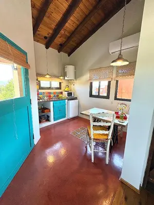 a kitchen with a table and a dining room at La Cambicha Ranchos in Los Reartes