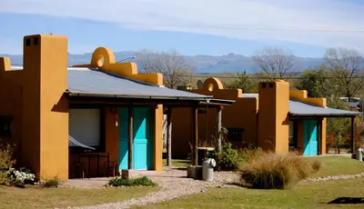 a row of houses with blue and brown at La Cambicha Ranchos in Los Reartes