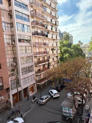 a tall building with cars parked in front of it at Apartamento en Pleno Nueva Córdoba, Garzon, By ApartCba in Cordoba