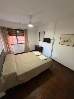 a hotel room with a bed and a window at Apartamento en Pleno Nueva Córdoba, Garzon, By ApartCba in Cordoba
