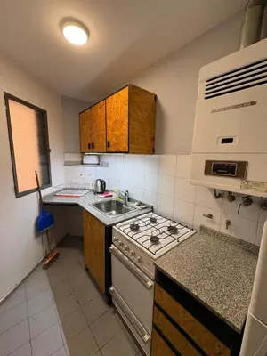 a kitchen with a stove and a sink at Apartamento en Pleno Nueva Córdoba, Garzon, By ApartCba in Cordoba
