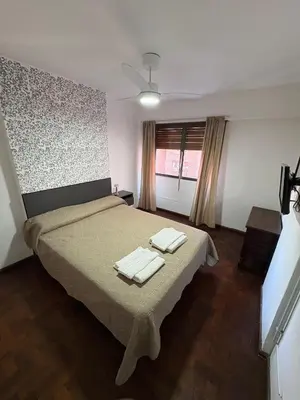 a bedroom with a bed with two towels on it at Apartamento en Pleno Nueva Córdoba, Garzon, By ApartCba in Cordoba