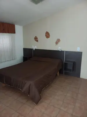 a bedroom with a bed and two lights on the wall at Casas Mya in Santa Rosa de Calamuchita