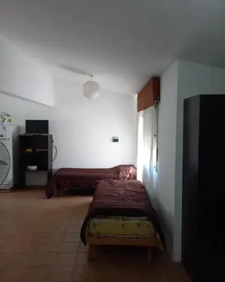 a bedroom with a bed and a tv in it at Casas Mya in Santa Rosa de Calamuchita