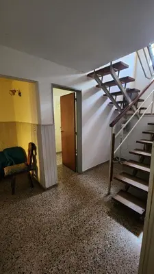 a room with a staircase and a room with a door at Casas Mya in Santa Rosa de Calamuchita