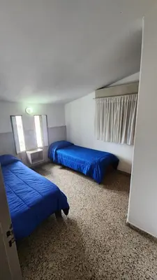 a bedroom with two beds with blue sheets in it at Casas Mya in Santa Rosa de Calamuchita
