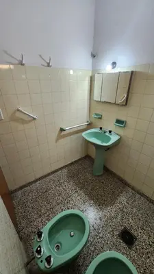 a bathroom with a green sink and a toilet at Casas Mya in Santa Rosa de Calamuchita