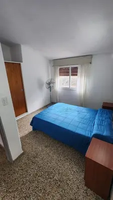 a bedroom with a blue bed and a window at Casas Mya in Santa Rosa de Calamuchita