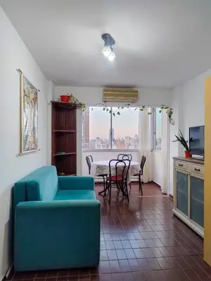 a living room with a blue couch and a table at El Depto del Rey in Cordoba