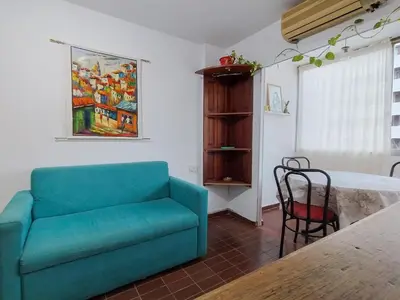 a living room with a blue couch and a table at El Depto del Rey in Cordoba