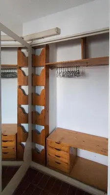 a room with wooden shelves and a wall at El Depto del Rey in Cordoba