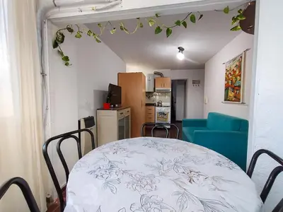 a table and chairs in a room with a kitchen at El Depto del Rey in Cordoba