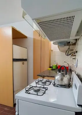 a kitchen with a stove with a tea kettle on it at El Depto del Rey in Cordoba