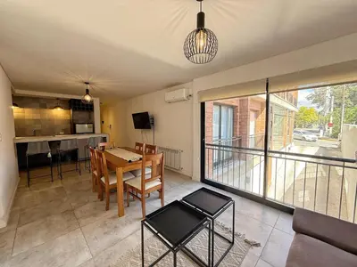 a kitchen and dining room with a table and chairs at Edificio Catalina in Villa Carlos Paz
