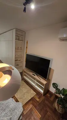 a living room with a flat screen tv on a wall at Departamento Nueva Córdoba - Parque Sarmiento in Cordoba