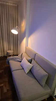 a couch with pillows on it in a living room at Departamento Nueva Córdoba - Parque Sarmiento in Cordoba