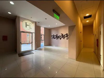 an empty lobby of a building with a sign on the wall at Torres H Güemes in Cordoba