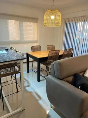 a living room with a table and chairs and a couch at Departamento Venetto 8 in Villa Carlos Paz