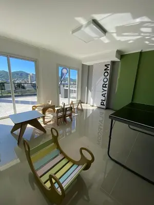 a room with a bench and a table and chairs at Departamento Venetto 8 in Villa Carlos Paz