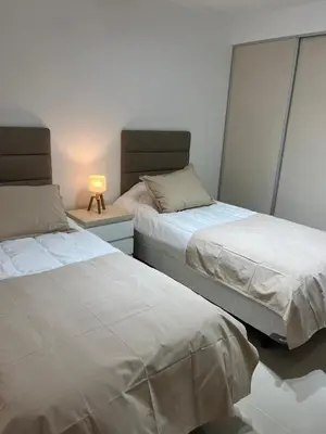 two beds sitting next to each other in a bedroom at Departamento Venetto 8 in Villa Carlos Paz