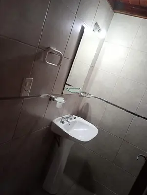 a bathroom with a sink and a mirror at Cabañas Los Abuelos in Santa Rosa de Calamuchita