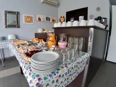 a table with plates and cups and plates of food at Del Vaiven in Villa Carlos Paz