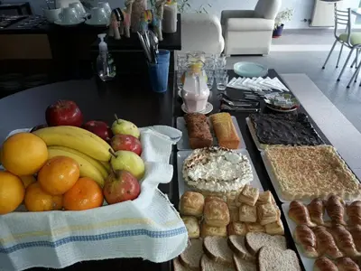 a table with a bunch of different types of food at Del Vaiven in Villa Carlos Paz