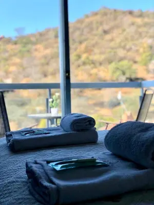 two towels on a table with a view of a mountain at Del Vaiven in Villa Carlos Paz